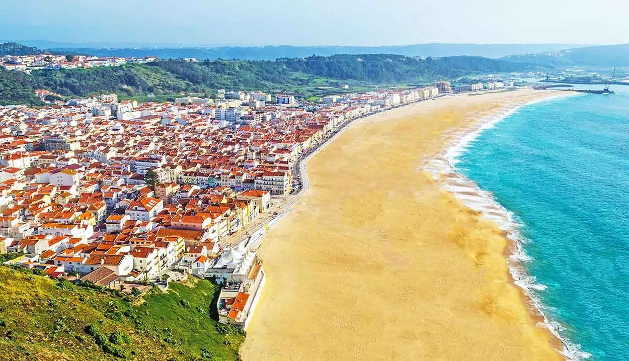 Aerial view of Nazaré's golden beach and whitewashed town