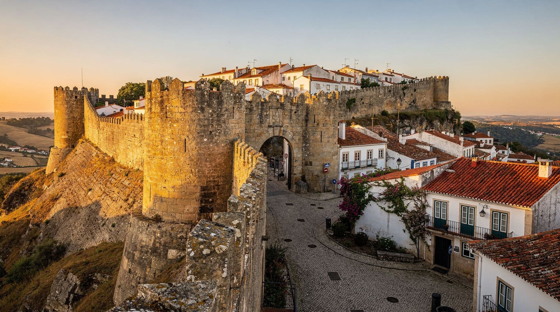 Golden light on the medieval walls and castle of Óbidos